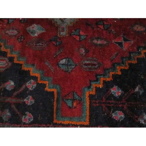 75 - Persian Hamadan village rug, the blue ground with three red ground medallions, the field with variou... 