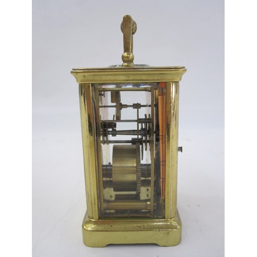 111 - A French carriage clock, Roman numeral enamel dial, 10.5cm high not including handle