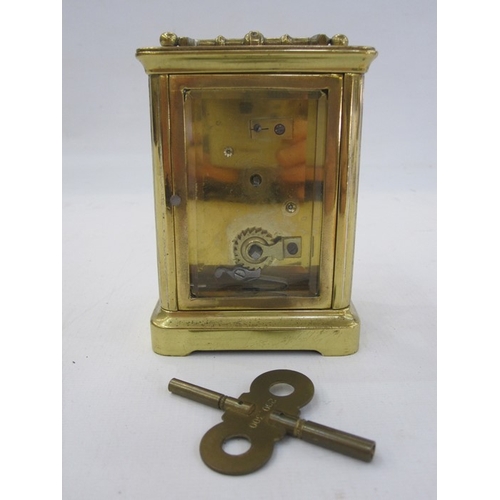 111 - A French carriage clock, Roman numeral enamel dial, 10.5cm high not including handle