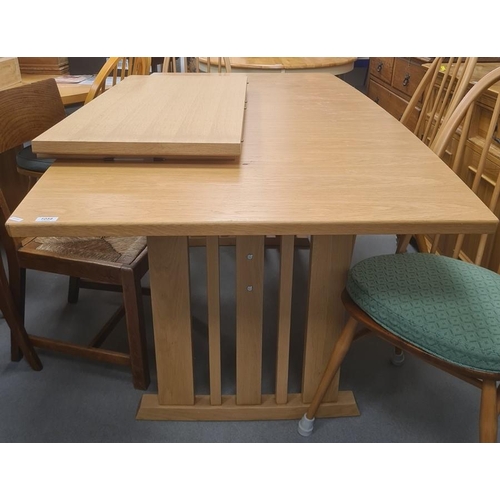 1023 - 20th century light oak extending dining table on pillar end supports