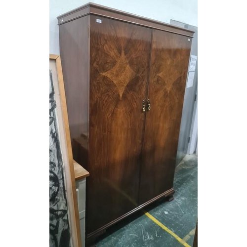 1027 - Mid 20th century walnut two-door wardrobe on ogee bracket feet, 115 x 184cm