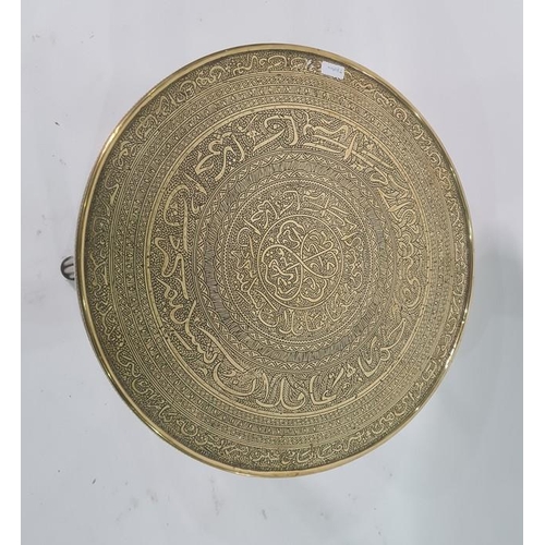 1052 - Eastern brass-topped circular table, the brass top with decorative engraving, on reeded base