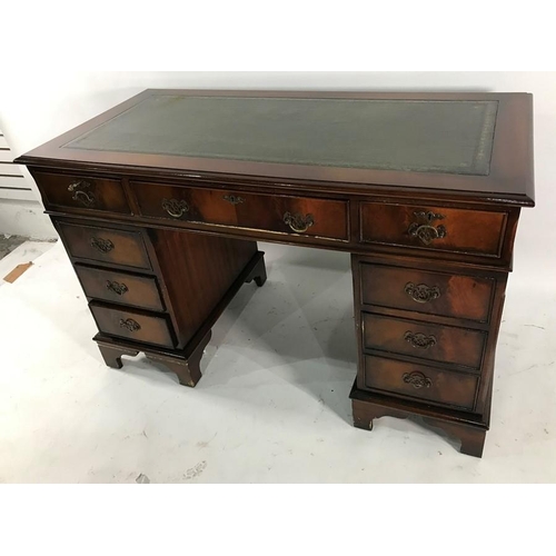 1206 - 20th century pedestal desk with green leather inset top above nine assorted drawers, on bracket feet... 