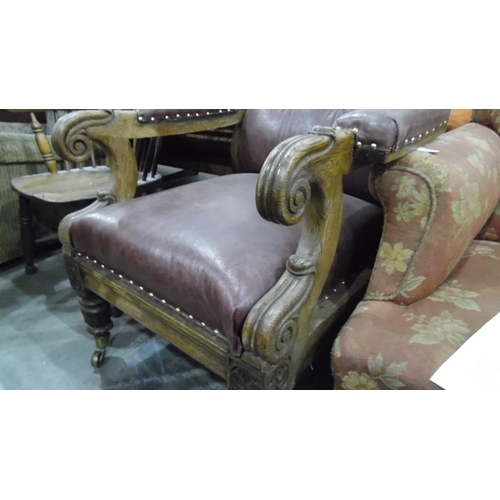 1242 - Late 19th century William IV style oak-framed library armchair with leather upholstered scrolling ar... 