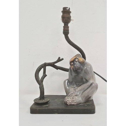 13 - Ceramic monkey and metal table lamp, the monkey seated beside twisted branch on metal base, 19cm x 3... 