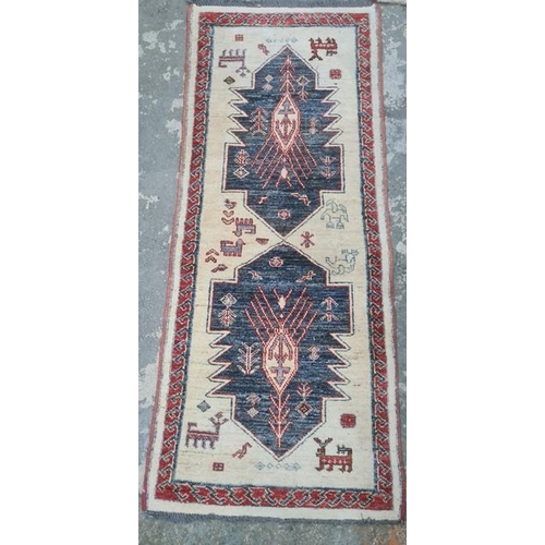 1329 - Three assorted modern rugs including cream ground example with two blue lozenges, decorated with ani... 