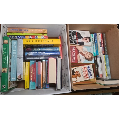 235 - Four boxes of assorted books including fiction, Matt cartoon annuals, recipe books, etc. (4)