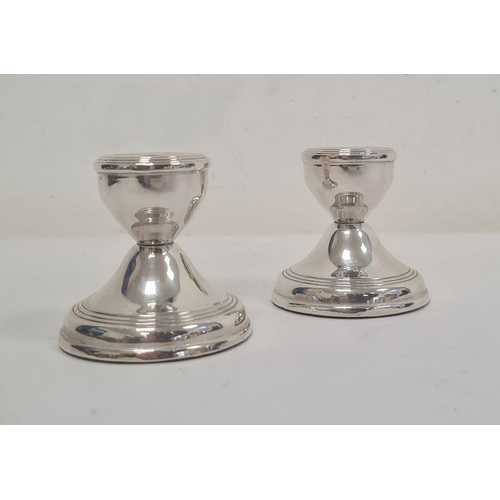 301 - Pair of 20th century silver-mounted squat candlestick holders, reeded decoration, on circular bases,... 