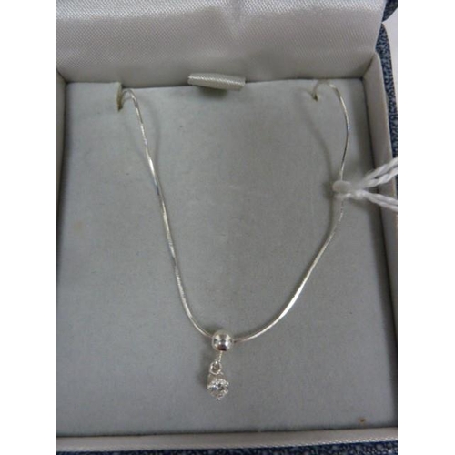 340 - Solitaire diamond drop pendant, claw set in silver mount, on fine chain, the stone approx 0.10ct