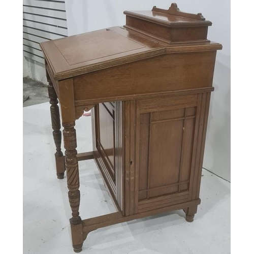 1135 - 20th century Davenport desk with lift-top compartment to top revealing fitted interior, above the br... 