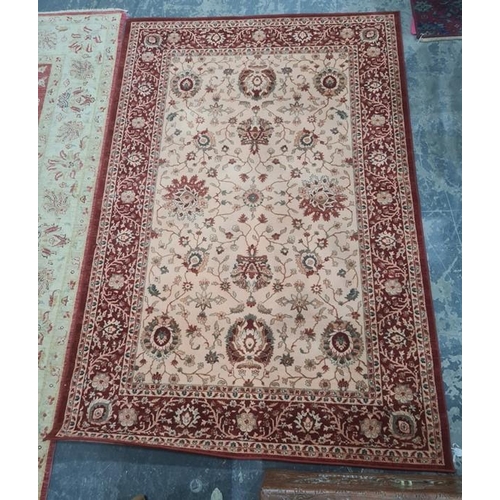 1266 - Modern machine-made cream ground rug with red foliate border, 237 x 162cm