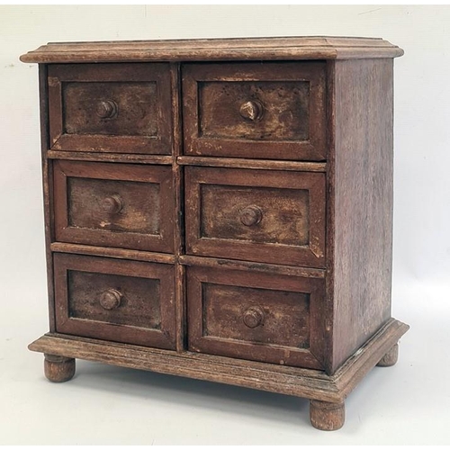 1287 - Miniature chest of six short drawers, rectangular top with moulded edge, the whole raised on turned ... 