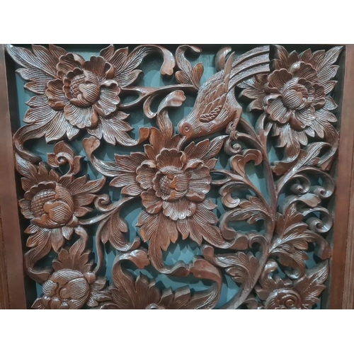 134 - Modern eastern carved stained wood panel featuring birds amongst foliage, 61cm x 153cm