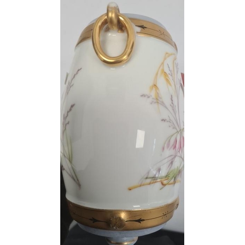 26 - Continental porcelain vase, the barrel-shaped body with gilt border and ring handles, painted with b... 