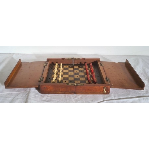 352 - A travel chess board, with one set of pieces stained red, one white, 20.2cm