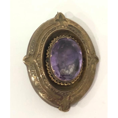 391 - Victorian amethyst oval brooch in gold-coloured mount, set single facet-cut stone, 5cm high