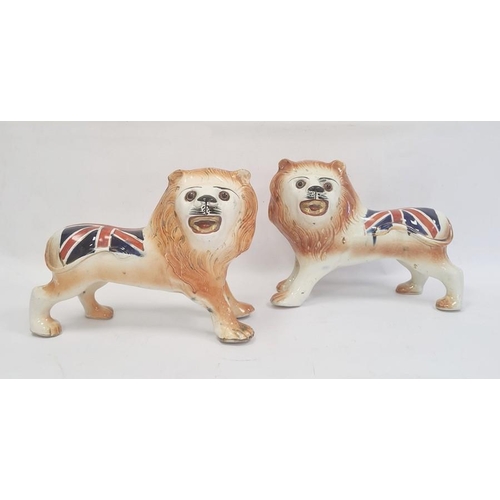 4 - Pair of Staffordshire-style pottery lions painted with Union Jacks, 25cm high x 32cm long (2)