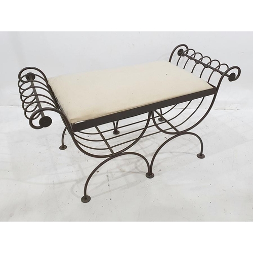 1418 - Modern wrought iron stool of scrolling design, with upholstered seat, 104cm wide