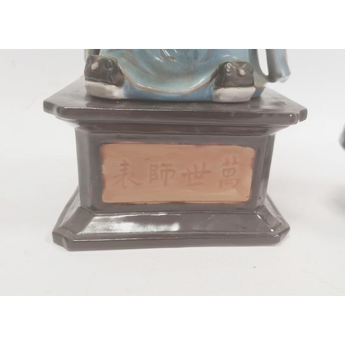 148 - Chinese tinted bisque and partly glazed figure of a sage in blue robes and on square ceramic plinth ... 