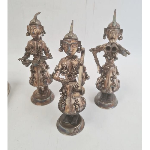 169 - Set of three white metal figures of musicians, the costume of each adorned with bells, approx 18cm h... 