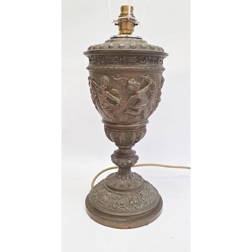 194 - Table lamp with 19th century oil lamp body, embossed cherub decoration, 35cm high