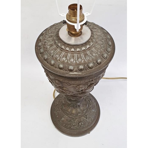 194 - Table lamp with 19th century oil lamp body, embossed cherub decoration, 35cm high