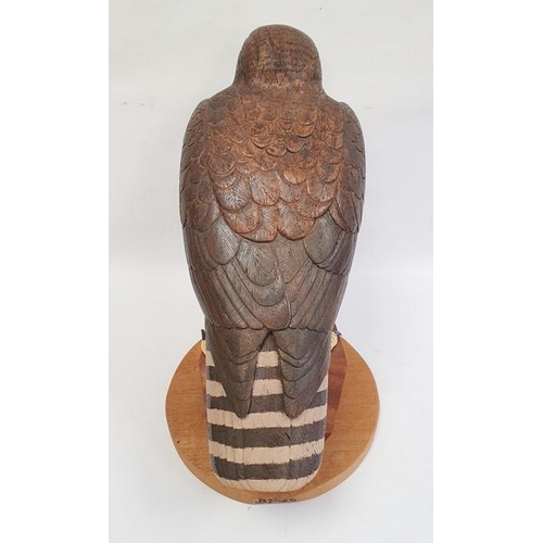 195 - Carved wood figure of bird of prey, marked verso 'B2000 1/1', 42cm high