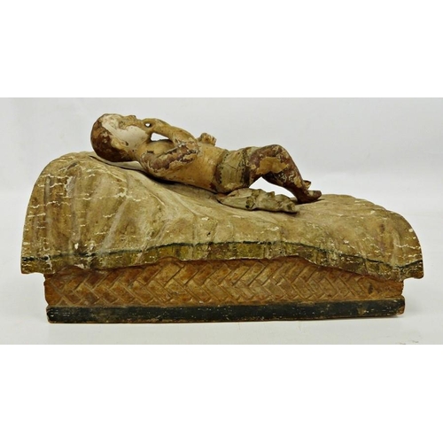 225 - Carved wood and gesso figure of child on bed, worn polychrome finish, probably Italian, possibly 18t... 