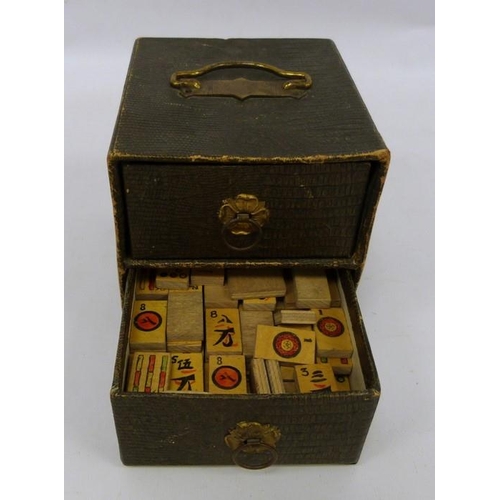 231 - Miniature cupboard chest of two drawers and contents of gaming counters and Mahjong tiles