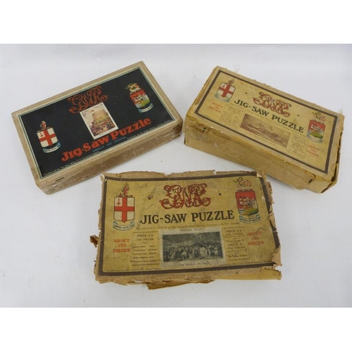 244 - Three boxes of wooden jigsaw puzzles and a lace tray cloth