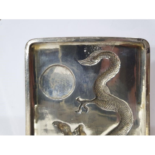 454 - Chinese silver cigarette case, rectangular and curved, the hinged lid repousse with dragon chasing p... 