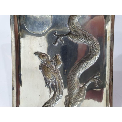 454 - Chinese silver cigarette case, rectangular and curved, the hinged lid repousse with dragon chasing p... 