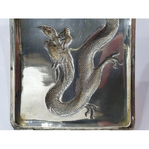 454 - Chinese silver cigarette case, rectangular and curved, the hinged lid repousse with dragon chasing p... 