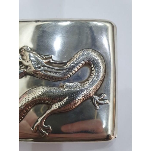 454 - Chinese silver cigarette case, rectangular and curved, the hinged lid repousse with dragon chasing p... 