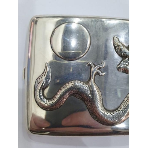 454 - Chinese silver cigarette case, rectangular and curved, the hinged lid repousse with dragon chasing p... 