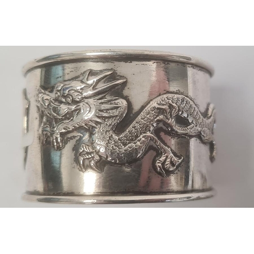 464 - Pair Chinese napkin rings, each decorated with dragons and a vacant shield-shaped cartouche