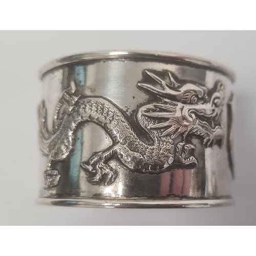 464 - Pair Chinese napkin rings, each decorated with dragons and a vacant shield-shaped cartouche