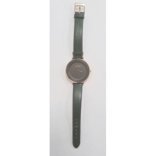 505 - Lady's Skagen wristwatch with gilt metal and plain black matt face, on green leather strap