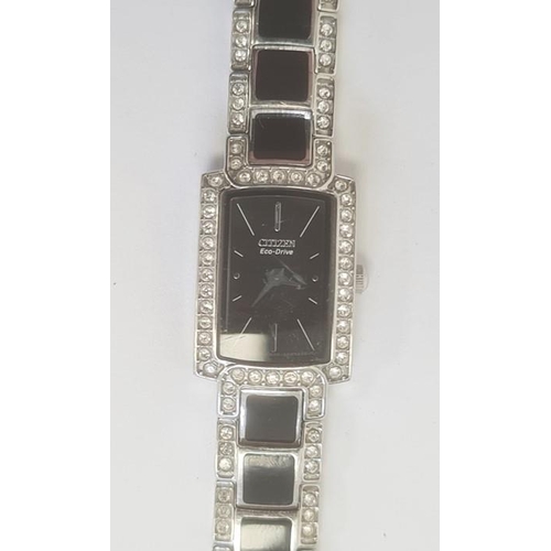 508 - Lady's Citizen Eco Drive white metal dress watch with faux-diamond border, black enamel face, stone ... 