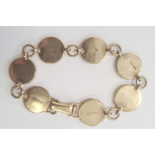 585 - South African 9ct gold and ivory bracelet, seven circular ivory mounts depicting hunting scenes, mar... 