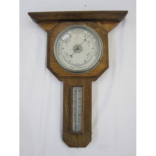 1005 - 20th century oak aneroid barometer, geometric design 48cm