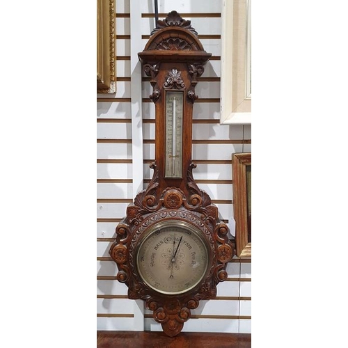 1008 - Victorian carved walnut aneroid barometer with carved arched pediment, thermometer above the dial wi... 