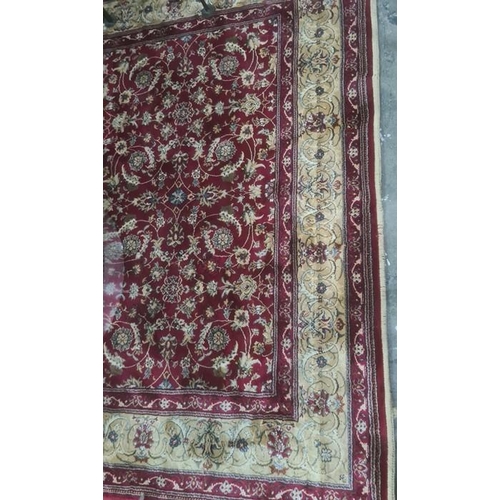 1034 - Red ground Kashmiri rug, allover floral decoration with gold border, 240 x 160cm