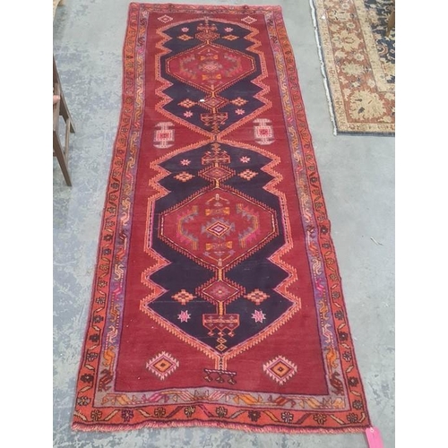 1048 - Large red ground Iranian runner, multi-coloured unique medallion design, 330 x 120cm