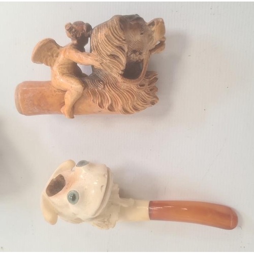 244 - Cherub and Pekinese dog meerschaum pipe, another, frog with green glass eyes, cased and two other pi... 