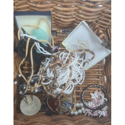 324 - Basket of costume jewellery including wooden bangles, bead necklaces, a Swatch wristwatch etc.