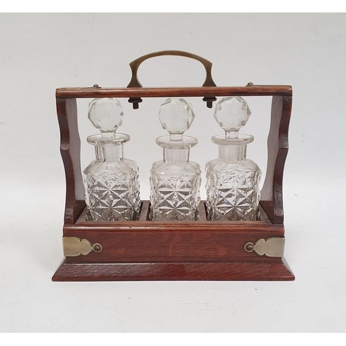 347 - Miniature tantalus, the oak frame with silver plated mounts and handle and fitted with three cut gla... 