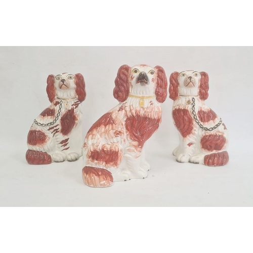 36 - Pair of Staffordshire pottery models of spaniels, 22cm high, and another similar, circa 1880, each e... 