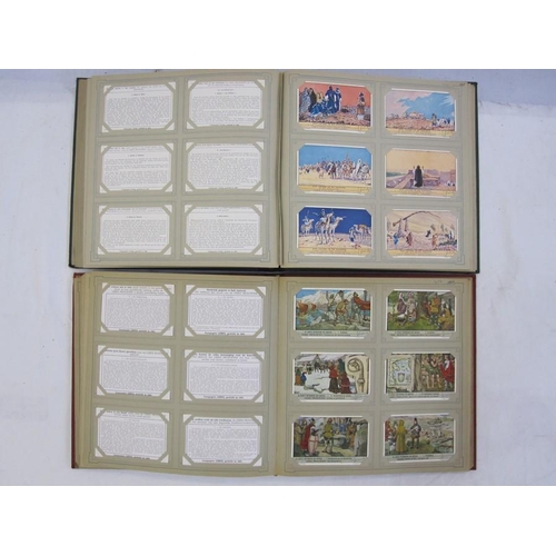 216 - Two albums of trade cards 'Chromos Liebig Chromo's' including 'De Koppoortigen', 'De Kalevala', 'De ... 