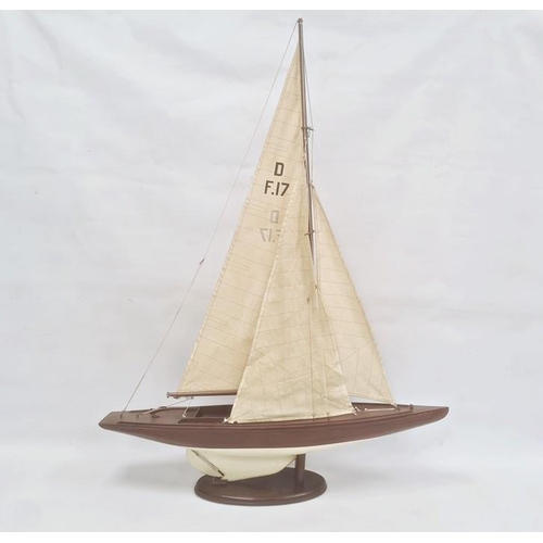 153 - Varnished and painted wood model yacht with canvas sails and the associated wooden stand, 102cm high... 